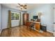 Bright bedroom with hardwood floors, an armoire, desk space and natural light at 208 Madeira Ave, Orlando, FL 32825