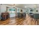Open concept living and dining room, perfect for entertaining, with wood floors at 208 Madeira Ave, Orlando, FL 32825