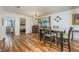 Spacious dining room with wood floors and an open concept layout that flows to the living room at 208 Madeira Ave, Orlando, FL 32825