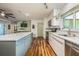 Open kitchen featuring a large island, stainless appliances, and modern finishes at 208 Madeira Ave, Orlando, FL 32825
