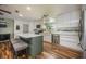 Bright kitchen with white cabinets, an island with seating, and modern stainless steel appliances at 208 Madeira Ave, Orlando, FL 32825