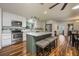 Bright kitchen with white cabinets, an island with seating, and modern stainless steel appliances at 208 Madeira Ave, Orlando, FL 32825