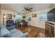 Inviting living room featuring hardwood floors, natural light, comfortable seating, and a ceiling fan at 208 Madeira Ave, Orlando, FL 32825