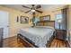 A well-lit main bedroom featuring hardwood floors, light yellow walls, art and furnishings at 208 Madeira Ave, Orlando, FL 32825