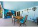 Enclosed patio with ample seating area, dining set, and unique wall art at 208 Madeira Ave, Orlando, FL 32825