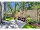 Serene backyard patio with stylish furniture, lush landscaping, and a privacy fence, perfect for outdoor entertaining at 2162 Lake Howell Preserve Ct, Maitland, FL 32751