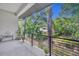 Balcony view overlooking lush greenery and mature trees at 2162 Lake Howell Preserve Ct, Maitland, FL 32751