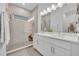 Modern bathroom with a glass-enclosed shower and double vanity with white countertops at 2162 Lake Howell Preserve Ct, Maitland, FL 32751