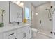 Bright bathroom features a white vanity, a framed mirror and a glass-enclosed shower with black hardware at 2162 Lake Howell Preserve Ct, Maitland, FL 32751