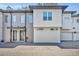 Contemporary townhome featuring a textured gray brick facade and a well-maintained paved driveway at 2162 Lake Howell Preserve Ct, Maitland, FL 32751