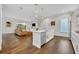 Spacious open floor plan: kitchen with island seating and hardwood floors flows into living area at 2162 Lake Howell Preserve Ct, Maitland, FL 32751