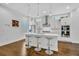 Modern kitchen with white cabinets, stainless steel appliances, pendant lighting, and dark hardwood floors at 2162 Lake Howell Preserve Ct, Maitland, FL 32751