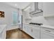 Modern kitchen featuring white cabinets, stainless steel appliances, and hardwood floors at 2162 Lake Howell Preserve Ct, Maitland, FL 32751
