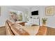 Bright living room featuring a leather sectional sofa and views of the backyard patio at 2162 Lake Howell Preserve Ct, Maitland, FL 32751