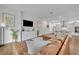 Open floor plan featuring a living room with a leather sectional and modern kitchen with island seating at 2162 Lake Howell Preserve Ct, Maitland, FL 32751