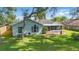 Inviting home exterior with a screened-in porch and spacious backyard, perfect for outdoor living and entertaining at 2277 Clearwater Dr, Deltona, FL 32738