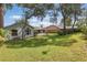 Large, grassy backyard with mature trees, perfect for outdoor activities at 2277 Clearwater Dr, Deltona, FL 32738