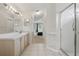 Bright bathroom featuring a double sink vanity, tiled floor and a glass-enclosed shower at 2277 Clearwater Dr, Deltona, FL 32738