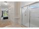 Bright bathroom featuring a glass-enclosed shower with tiled walls and shelving at 2277 Clearwater Dr, Deltona, FL 32738