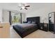 Elegant bedroom with a vaulted ceiling, ceiling fan, large window, and plush bed at 2277 Clearwater Dr, Deltona, FL 32738