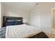 Bedroom with carpet, closet, and queen bed with blue pillows and a white comforter at 2277 Clearwater Dr, Deltona, FL 32738