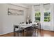 The dining room showcases sleek, modern furnishings and sunlit backyard views at 2277 Clearwater Dr, Deltona, FL 32738