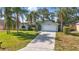 Attractive single-story home with a well-kept lawn, mature trees, and a two-car garage at 2277 Clearwater Dr, Deltona, FL 32738