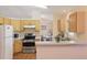 Functional kitchen with stainless steel appliances, adjacent to dining area, offers convenient living at 2277 Clearwater Dr, Deltona, FL 32738