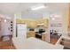 Bright kitchen featuring light wood cabinets, stainless steel appliances, and an adjacent dining area at 2277 Clearwater Dr, Deltona, FL 32738