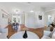 Bright living room boasts a white sofa, hardwood floors, and adjoins the dining area at 2277 Clearwater Dr, Deltona, FL 32738