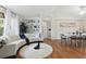 Bright living room boasts a white sofa, hardwood floors, decorative shelving, and dining area at 2277 Clearwater Dr, Deltona, FL 32738