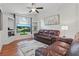 Comfortable living room with ceiling fan, built-in shelving, and plush leather seating at 2277 Clearwater Dr, Deltona, FL 32738