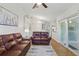 Spacious living area with hardwood floors, large windows, and access to the kitchen at 2277 Clearwater Dr, Deltona, FL 32738