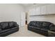 The Living Room features two black leather sofas and tiled floors at 2277 Clearwater Dr, Deltona, FL 32738
