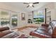 Cozy living room boasts vaulted ceilings, built-in shelving, and sliding glass doors to a lanai at 2277 Clearwater Dr, Deltona, FL 32738