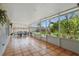 Relaxing screened patio with tiled floor and view of the garden at 2277 Clearwater Dr, Deltona, FL 32738