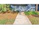 Condo exterior featuring stairs leading to second floor units and sidewalk up to units at 2301 Oak Park Way # 101, Orlando, FL 32822
