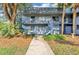Condo exterior featuring stairs leading to second floor units and sidewalk up to units at 2301 Oak Park Way # 101, Orlando, FL 32822