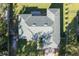 An aerial view of a home with a green roof with surrounding landscaping and a brick driveway at 2314 Pennsylvania Ave, Oviedo, FL 32765