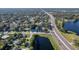 A neighborhood aerial view highlighting a building with a blue roof, located next to a pond and a highway at 2314 Pennsylvania Ave, Oviedo, FL 32765