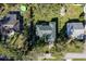 An aerial view of a home with a green roof in a residential neighborhood with a pool and green lawns at 2314 Pennsylvania Ave, Oviedo, FL 32765