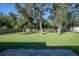 Expansive backyard with healthy green lawn and a wooden fence, perfect for outdoor activities at 2314 Pennsylvania Ave, Oviedo, FL 32765