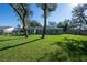 View of the home's backyard with healthy green lawn and mature shade trees at 2314 Pennsylvania Ave, Oviedo, FL 32765