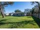 A view of a home's backyard with a large lawn and a wood fence that provides plenty of privacy at 2314 Pennsylvania Ave, Oviedo, FL 32765