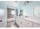 Bathroom showing tiled walls and floors, with a mirror, and a vanity at 2314 Pennsylvania Ave, Oviedo, FL 32765