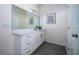 Bright bathroom featuring tile flooring, a vanity with white cabinets and a large mirror and overhead lighting at 2314 Pennsylvania Ave, Oviedo, FL 32765