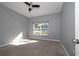 Neutral bedroom with a carpet flooring, a ceiling fan, and large window that provides lots of natural light at 2314 Pennsylvania Ave, Oviedo, FL 32765