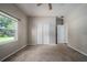 Bedroom with a window, ceiling fan, closet, and a door leading to other rooms at 2314 Pennsylvania Ave, Oviedo, FL 32765