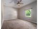 This bedroom has a ceiling fan and view to the yard through a window at 2314 Pennsylvania Ave, Oviedo, FL 32765