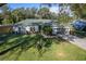 Charming single-story home with a gray exterior, a well-manicured lawn, and a paved driveway leading to a two-car garage at 2314 Pennsylvania Ave, Oviedo, FL 32765